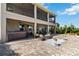 Brick backyard patio featuring a hot tub, seating, and a lovely view of tropical landscaping at 3404 Shallow Cove Ln, Clermont, FL 34711