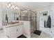 Bathroom featuring a glass enclosed shower, dual vanities, and tiled floors at 3404 Shallow Cove Ln, Clermont, FL 34711