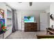 Bedroom with a dresser, a television, and a ceiling fan at 3404 Shallow Cove Ln, Clermont, FL 34711