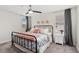 Bedroom with a ceiling fan, an iron bed frame, neutral walls, and gray curtains at 3404 Shallow Cove Ln, Clermont, FL 34711