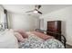 Bedroom featuring a ceiling fan, an iron bed frame, and a dresser at 3404 Shallow Cove Ln, Clermont, FL 34711