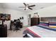 Bedroom with a ceiling fan, a desk with a chair, and a wooden dresser at 3404 Shallow Cove Ln, Clermont, FL 34711