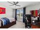 Bedroom featuring a ceiling fan, blue curtains, and a desk with an office chair at 3404 Shallow Cove Ln, Clermont, FL 34711
