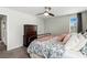 Bedroom with an iron bed frame, a ceiling fan, and a wooden dresser at 3404 Shallow Cove Ln, Clermont, FL 34711