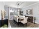 Formal dining room featuring a large table with seating for eight, a stylish light fixture, and neutral wall paint at 3404 Shallow Cove Ln, Clermont, FL 34711