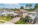 Aerial view of a two-story home with mature landscaping and a brick driveway at 3404 Shallow Cove Ln, Clermont, FL 34711