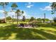 Picturesque backyard featuring a fire pit and seating surrounded by a lush lawn at 3404 Shallow Cove Ln, Clermont, FL 34711