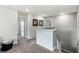 Bright upstairs hallway with neutral colors, carpeted flooring, and multiple doors at 3404 Shallow Cove Ln, Clermont, FL 34711