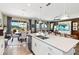 Bright open concept kitchen featuring large island with sink, stainless steel appliances, and views to the dining and living area at 3404 Shallow Cove Ln, Clermont, FL 34711