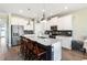 This kitchen has an island with bar stool seating, stainless appliances, and modern pendant lighting at 3404 Shallow Cove Ln, Clermont, FL 34711