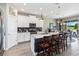 A bright kitchen showcases a central island with seating, stainless steel appliances, and modern pendant lighting at 3404 Shallow Cove Ln, Clermont, FL 34711