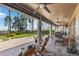 Wide-open patio includes a hot tub, chairs, a ceiling fan, and a manicured lawn with water view at 3404 Shallow Cove Ln, Clermont, FL 34711