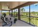 Screened porch with lovely view of the lush green backyard, a lake, and mature trees at 3404 Shallow Cove Ln, Clermont, FL 34711