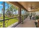 Screened porch with lovely view of the lush green backyard, a lake, and mature trees at 3404 Shallow Cove Ln, Clermont, FL 34711
