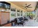Covered patio featuring an outdoor ceiling fan and comfy seating, perfect for relaxing at 3404 Shallow Cove Ln, Clermont, FL 34711