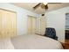 Bedroom featuring a ceiling fan, closet, and comfortable armchair at 3501 Amigos Ave, Orlando, FL 32808