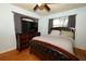 Comfortable bedroom with hardwood floors, a large bed, and natural light at 3501 Amigos Ave, Orlando, FL 32808
