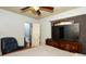 Comfortable bedroom featuring a ceiling fan, armchair, and an adjacent bathroom at 3501 Amigos Ave, Orlando, FL 32808