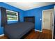 Bedroom with a plush bed, hardwood floors, and a bright window at 3501 Amigos Ave, Orlando, FL 32808