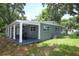 Rear exterior view of a single Gathering home with a covered patio and spacious lot at 3501 Amigos Ave, Orlando, FL 32808