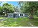 Charming single-story home with a well-maintained lawn, mature trees, and inviting curb appeal at 3501 Amigos Ave, Orlando, FL 32808