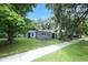 Charming single-story home with a well-maintained lawn, mature trees, and inviting curb appeal at 3501 Amigos Ave, Orlando, FL 32808