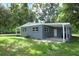 A single story home with a grey exterior, large lot and covered parking at 3501 Amigos Ave, Orlando, FL 32808