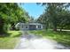 Home featuring a well maintained yard, mature trees and grey paint at 3501 Amigos Ave, Orlando, FL 32808