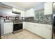 Well-equipped kitchen with white cabinets, granite counters, tiled backsplash, and stainless steel oven at 3501 Amigos Ave, Orlando, FL 32808