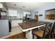 Bright kitchen with white cabinets, stainless steel appliances, tile backsplash, and an eat-in table at 3501 Amigos Ave, Orlando, FL 32808