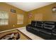 Cozy living room, with a leather sofa, neutral tiling, and good natural light at 3501 Amigos Ave, Orlando, FL 32808