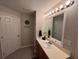 Bright bathroom features a modern vanity, a large mirror, and ample lighting at 428 Danube Way, Kissimmee, FL 34759