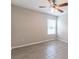 Inviting bedroom features light walls and tile floor, illuminated by a window at 428 Danube Way, Kissimmee, FL 34759