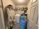 Efficient laundry room with washer, dryer, and storage shelving at 428 Danube Way, Kissimmee, FL 34759