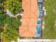 Aerial view of townhomes with red tile roofs, private pools, and lush greenery at 4558 Baleno Ln, Kissimmee, FL 34746