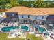 Aerial view of private screened-in pools and outdoor patios in a townhouse community at 4558 Baleno Ln, Kissimmee, FL 34746