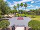 Basketball court surrounded by palm trees and green grass, with the community name 'Bella Vida' on the court at 4558 Baleno Ln, Kissimmee, FL 34746