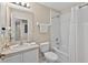 Well-lit bathroom featuring a vanity, toilet, and a bathtub with a shower at 4558 Baleno Ln, Kissimmee, FL 34746