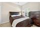 Cozy bedroom with a queen-sized bed, a nightstand, a chest of drawers, and natural light from the window at 4558 Baleno Ln, Kissimmee, FL 34746