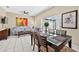 Bright dining area features a glass-top table, sliding glass doors to patio, and neutral decor at 4558 Baleno Ln, Kissimmee, FL 34746