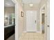 Welcoming foyer featuring tile flooring, neutral walls, and a modern light fixture at 4558 Baleno Ln, Kissimmee, FL 34746