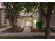 Inviting townhome entrance with lush landscaping, quaint benches, and a well-maintained facade at 4558 Baleno Ln, Kissimmee, FL 34746
