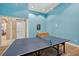 Recreation room featuring a ping pong table and modern decor with bright blue walls at 4558 Baleno Ln, Kissimmee, FL 34746