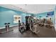 Well-equipped gym with modern exercise machines, ceiling fans, and ample natural light at 4558 Baleno Ln, Kissimmee, FL 34746