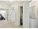 Hallway includes stackable washer and dryer, access to bedroom, and closet with shelving at 4558 Baleno Ln, Kissimmee, FL 34746