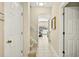 Bright hallway with access to the pool area, a staircase, and tiled floors at 4558 Baleno Ln, Kissimmee, FL 34746