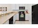 Well-lit kitchen with ample counter space, black appliances, and white cabinetry at 4558 Baleno Ln, Kissimmee, FL 34746