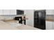 Well-lit kitchen with ample counter space, black appliances, and white cabinetry at 4558 Baleno Ln, Kissimmee, FL 34746
