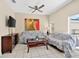 Comfortable living room with ceiling fan, tile flooring, and glass doors leading to the pool at 4558 Baleno Ln, Kissimmee, FL 34746