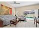 Bright living room with a ceiling fan, tiled floors, and access to the pool area at 4558 Baleno Ln, Kissimmee, FL 34746